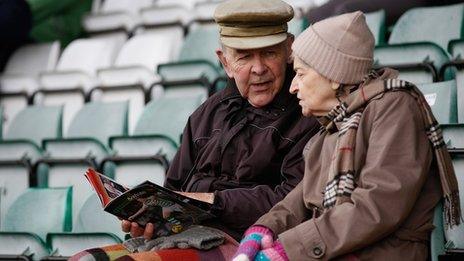 elderly couple at football match