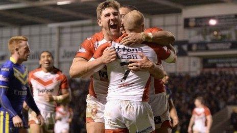 Luke Walsh of St Helens is congratulated on his try by team-mate Tommy Makinson