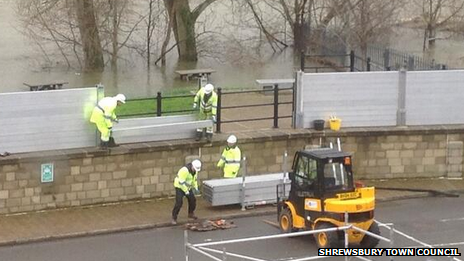 Workers take down some the the flood barriers in Frankwell