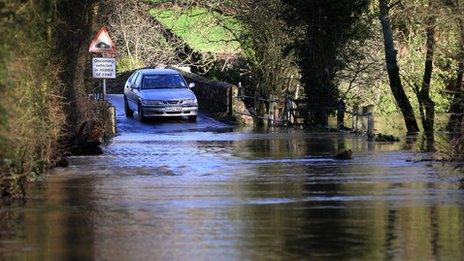 A car stops at flood waters in Kent