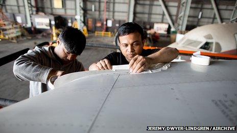 Workers prepare a DC-10