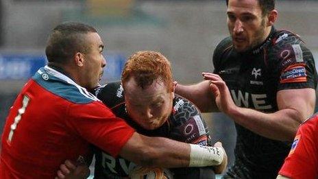 Munster wing Simon Zebo brings down Ospreys prop Dan Suter in the Pro12 at Liberty Stadium