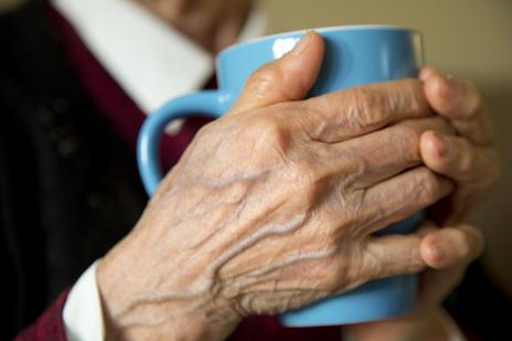 hand holding cup of tea