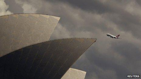 Qantas plane flies past Sydney Opera House