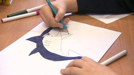 Child drawing a shark