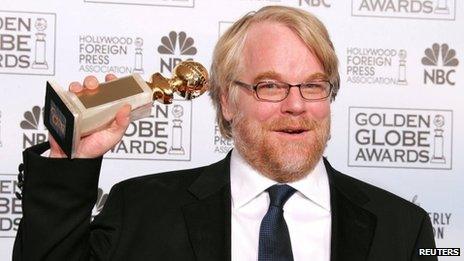 Philip Seymour Hoffman, hoisting a Golden Globe award for his role in Capote in 2006