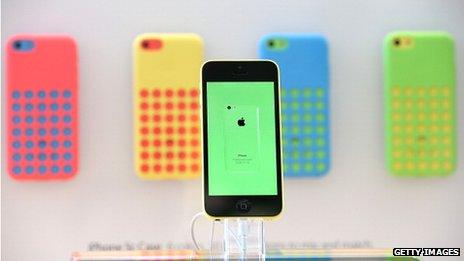 Apple iphone5c with phones in background