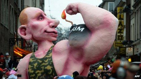 A float displaying a giant likeness of Russian President Vladimir Putin with a muscle like a bomb reading "Crimea" on his arm during the traditional Rose Monday parade in Dusseldorf, western Germany on 3 March 2014