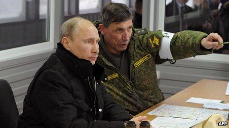 Russian President Vladimir Putin (left) listens to the head of the Russian army's main department of combat preparation Ivan Buvaltsev in the Leningrad region on 3 March 2014