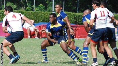 Barbados rugby sevens, in blue, in action against the USA.