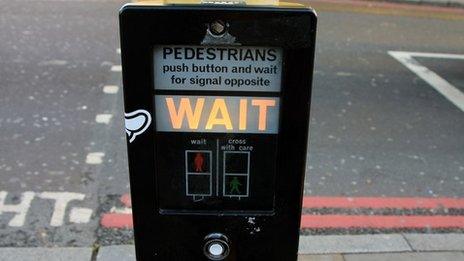 An illuminated wait signal at a pedestrian crossing