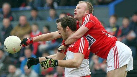 Derry's Emmet McGuckin comes under pressure from Michael Shields of Cork