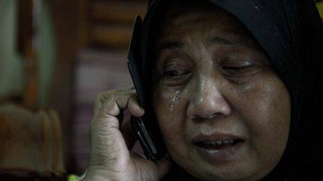 A relative of Norliakmar Hamid and Razahan Zamani, passengers on a missing Malaysia Airlines Boeing 777-200 plane, cries at their house in Kuala Lumpur on March 8, 2014. Malaysia and Vietnam on March 8 led a search for a Malaysia Airlines jet that has gone missing over Southeast Asia, as fears mounted over the fate of the 239 people aboard