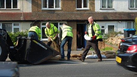 Removing sandbags in Godstone Road