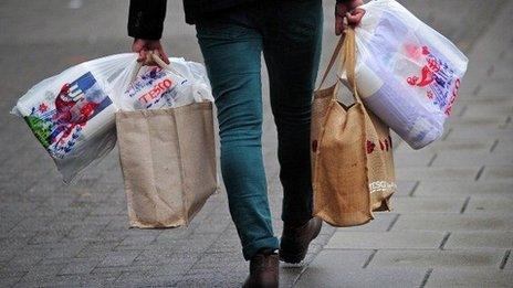 A man carrying Tesco shopping bags