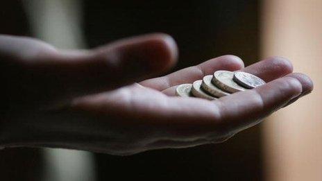 Hand holding coins