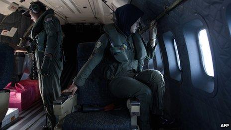 Malaysian air force crew members work during a search-and-rescue operation to find the missing Malaysia Airlines flight MH370 plane over the Strait of Malacca on 15 March 2014