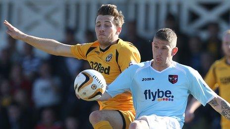 Newport's Max Porter and Exeter's Scot Bennett battle for the ball
