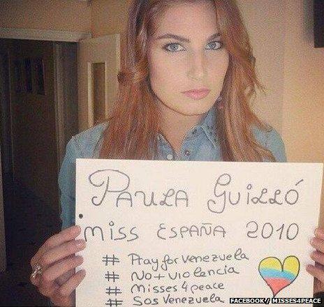 A Spanish beauty queen holds up a message of support for the people of Venezuela