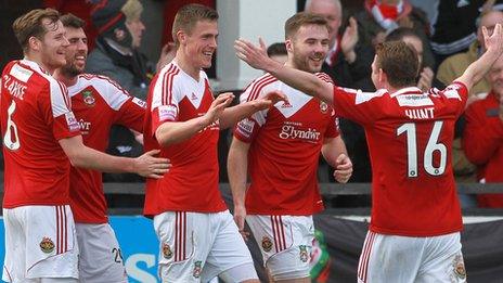 Wrexham players celebrate a goal at Hereford