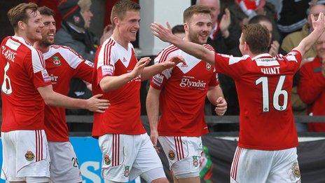 Wrexham players celebrate a goal at Hereford earlier in the season
