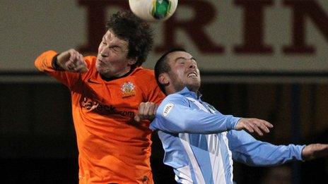 Glenavon's Kyle Neill and Stephen Hughes of Warrenpoint compete for a high ball