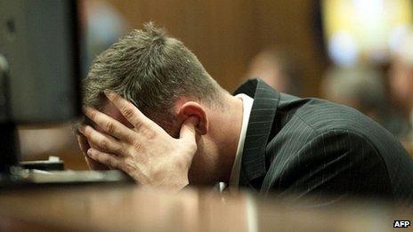 Oscar Pistorius puts his fingers in his ears during evidence in court