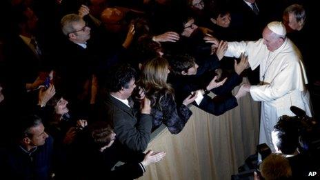 Pope Francis greets the faithful as he leaves at the end of a meeting with relatives of innocent mafia victims