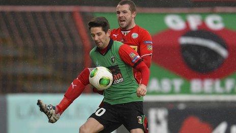 Glentoran's Curtis Allen and Cliftonville's Mark Smyth battle for possession at the Oval