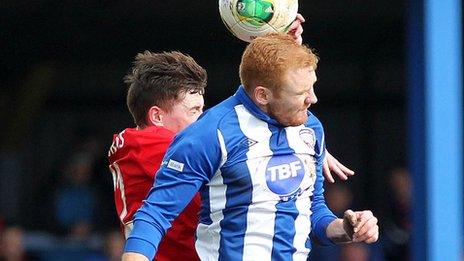 Linfield's BJ Burns challenges Coleraine midfielder Joe McNeill