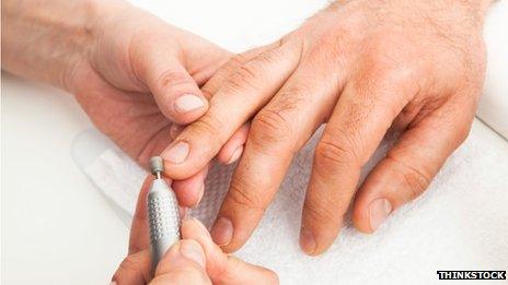 Man's hands being manicured