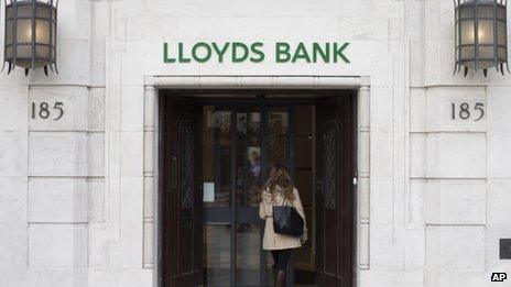 A customer walks into a branch of Lloyds Bank in London