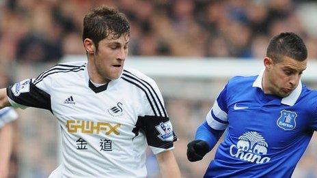 Ben Davies tackles Kevin Mirallas of Everton