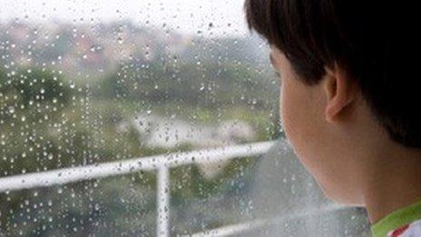 boy looking out of window