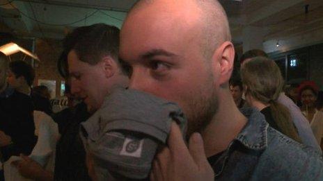 Man smelling t-shirt