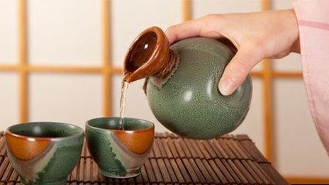 Woman pouring sake