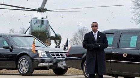 Secret service agent stands in front of a presidential vehicle in January 2010