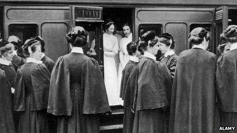 Nurses board a train In London to go to the continent