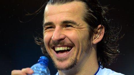 Joey Barton smiles during a QPR game in January