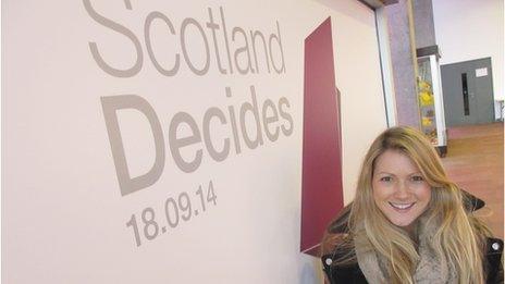 Shona in front of a Scotland Decides sign