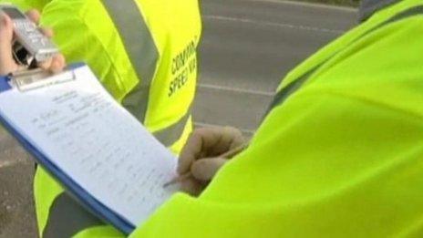 Volunteers writing registration numbers down