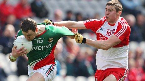 Ciaran McFaul and Keith Higgins contend for possession