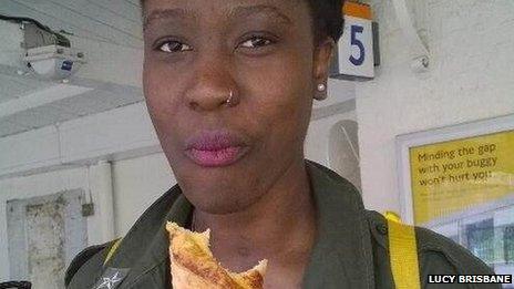 Woman eating a croissant at tube platform