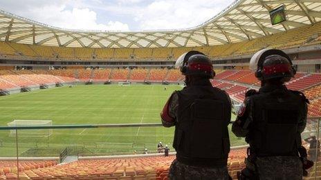 Riot police stand guard at the Arena Amazonia stadium in Manaus, on February 16, 2014.