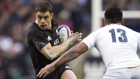 All Black fly-half Dan Carter takes on England's Manu Tuilagi