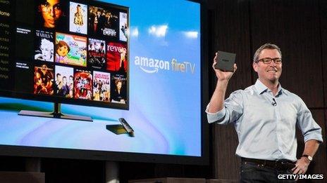 Amazon's vice president of Kindle, Peter Larsen, displays the Amazon Fire TV