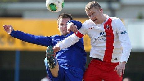 Dungannon's Ryan Harpur holds off the challenge of Mark Burns