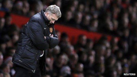 David Moyes standing on the touchline with his head down and arms folded