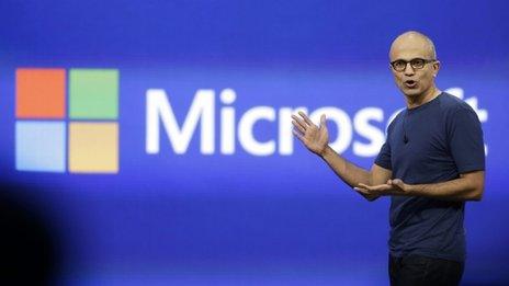 Satya Nadella and Microsoft logo