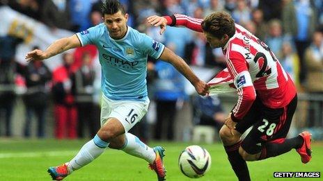 Manchester City's Argentinian striker Sergio Aguero goes past a defender